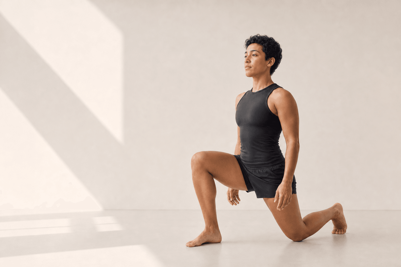 A woman preparing to train in a softly lit white studio